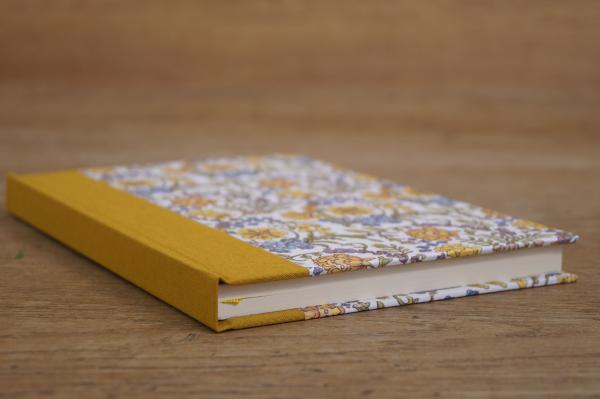 Retro notebook with illustrated flowers and mustard yellow cloth spine